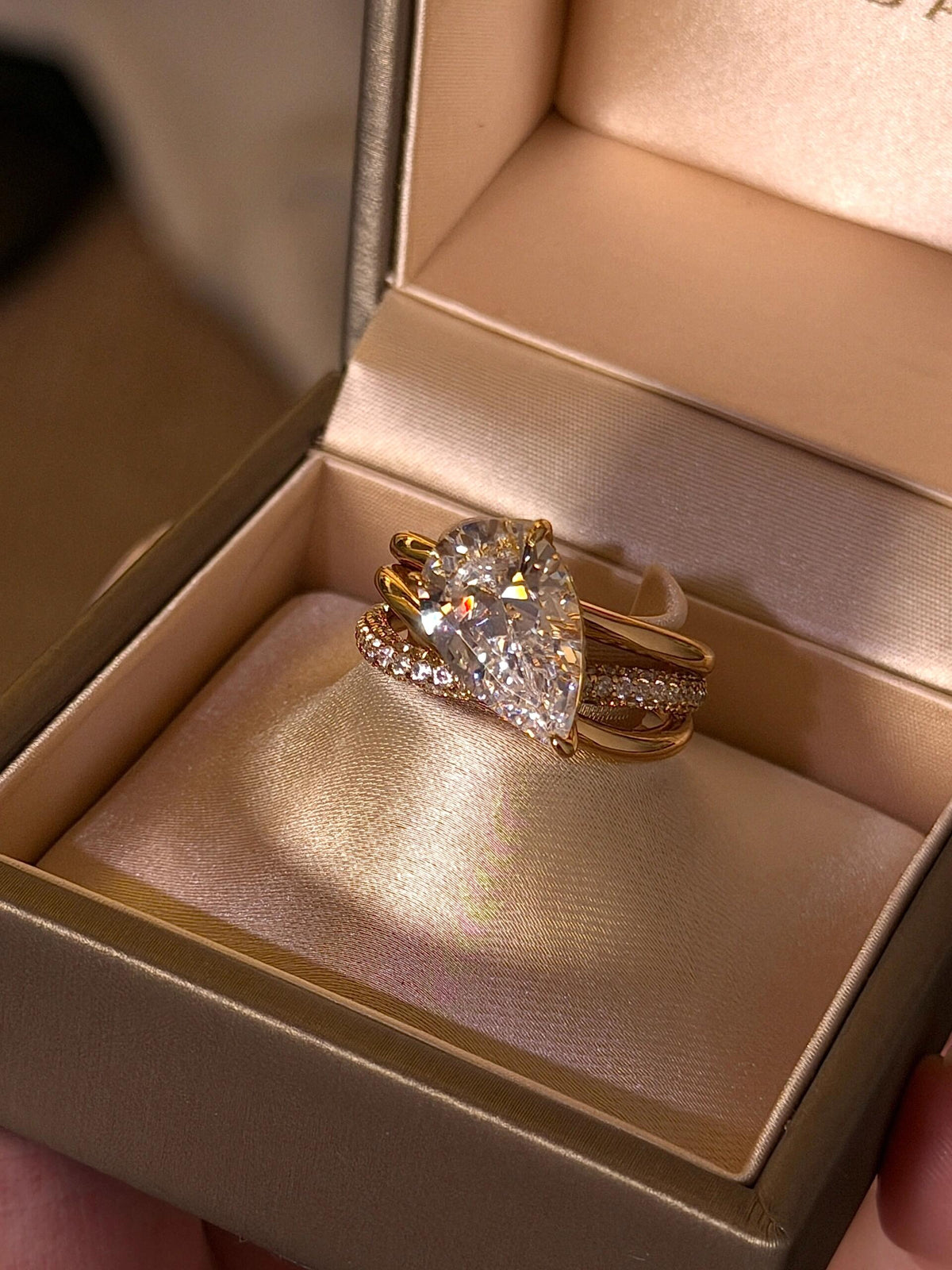 Aurore pear-cut moissanite crossover ring in yellow gold plating