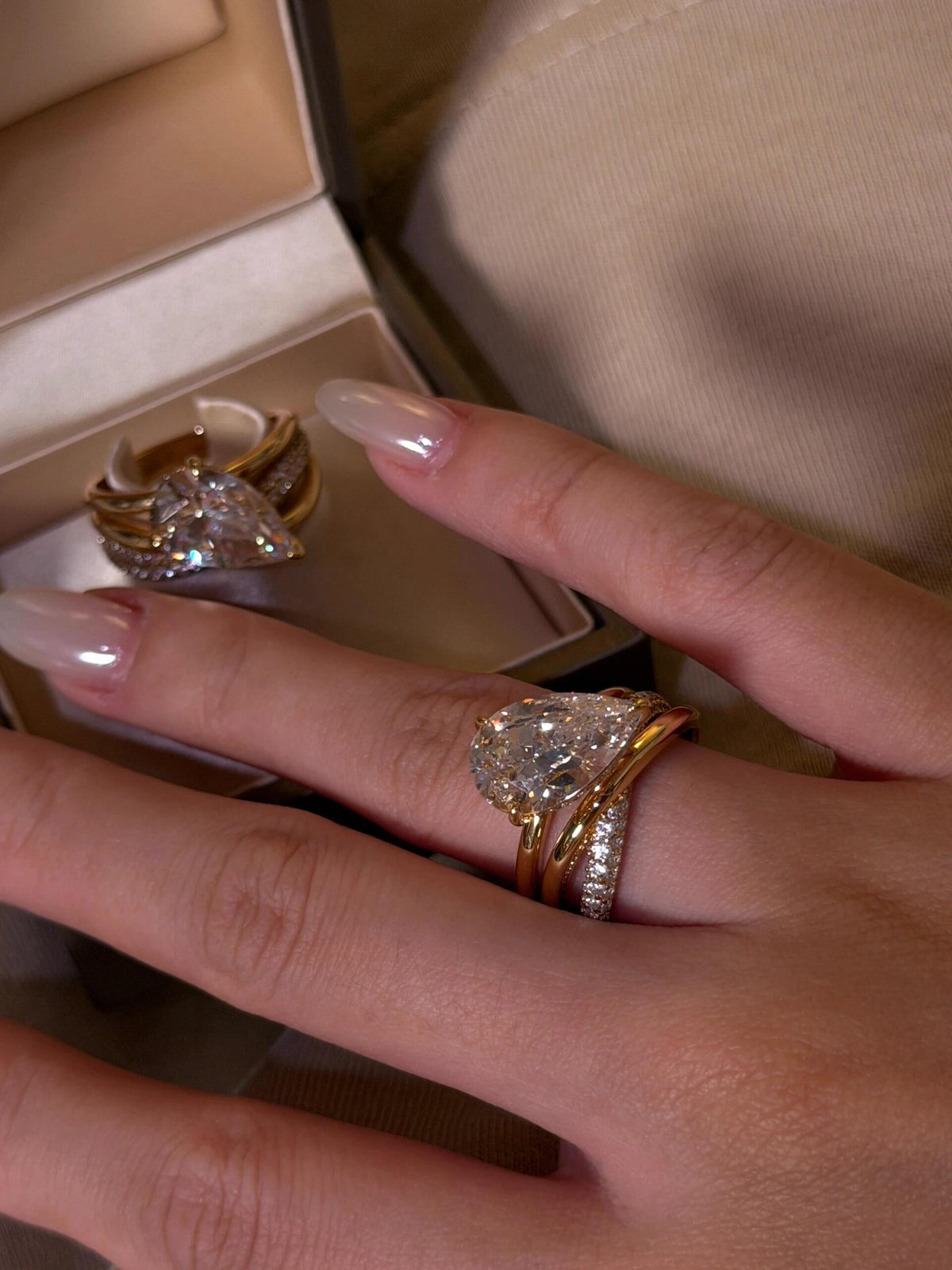 Aurore pear-cut crossover ring worn on the hand