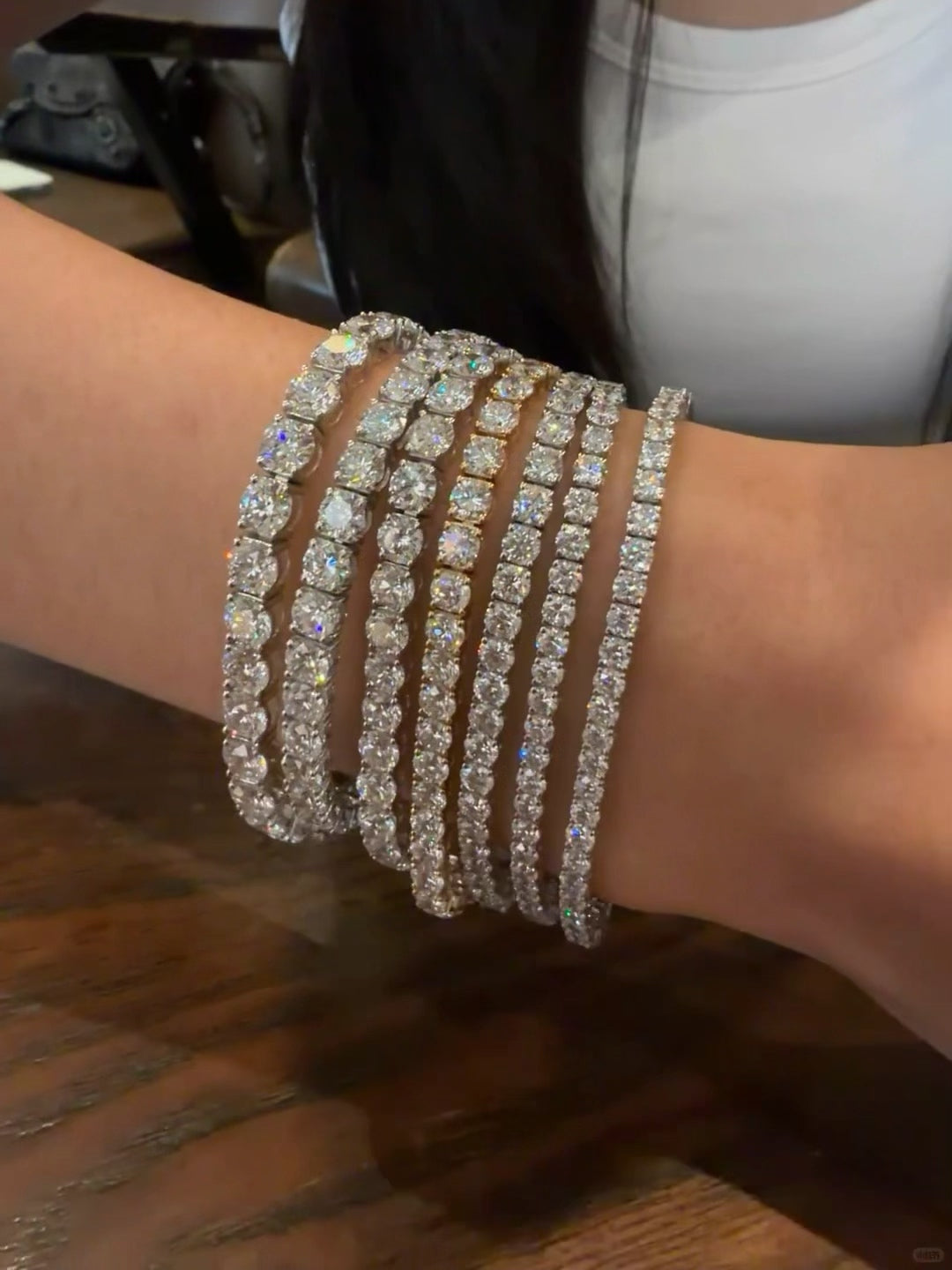 Tennis bracelets worn together on a wrist